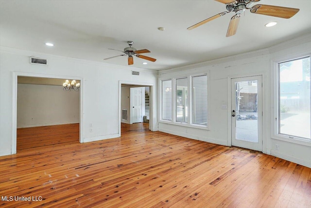 unfurnished living room featuring light hardwood / wood-style floors, crown molding, and ceiling fan with notable chandelier