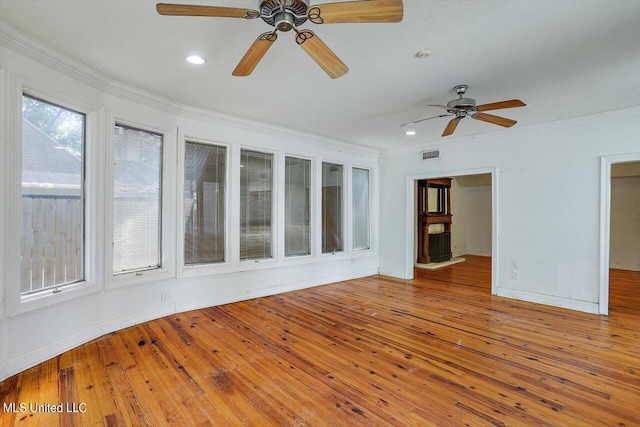 spare room with crown molding, hardwood / wood-style floors, and ceiling fan