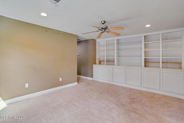 empty room with ceiling fan and light colored carpet