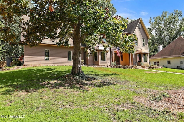 rear view of house with a lawn