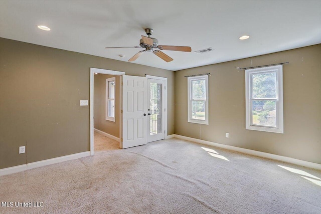 spare room with light carpet and ceiling fan