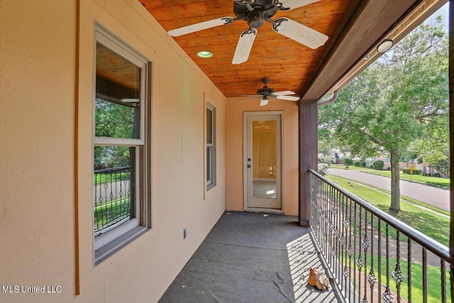 exterior space with a balcony and ceiling fan