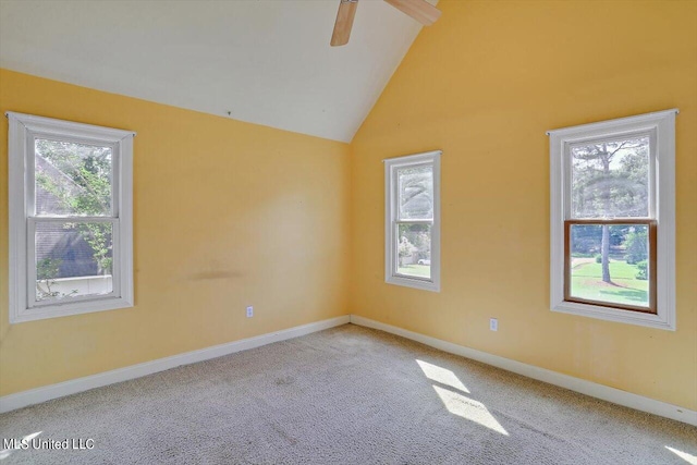 empty room with high vaulted ceiling, carpet flooring, a healthy amount of sunlight, and ceiling fan