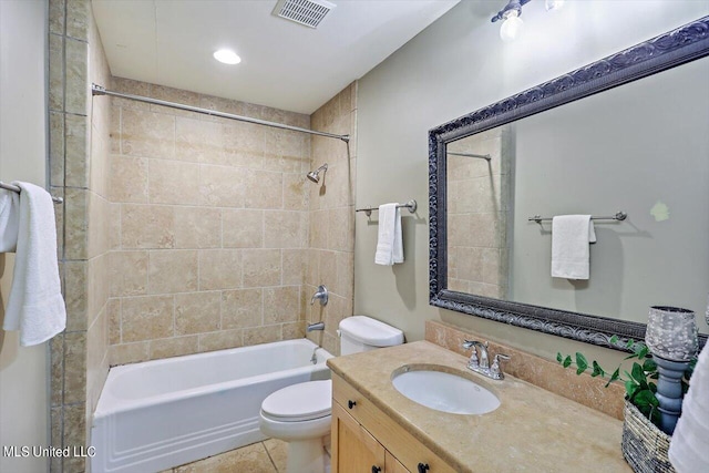 full bathroom with toilet, tiled shower / bath combo, vanity, and tile patterned flooring