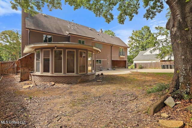 1771 Plantation Blvd, Jackson, MS 39211 - rear view of house with fence, a sunroom, brick siding, and a patio