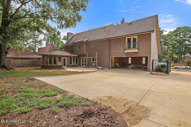 rear view of property featuring a sunroom