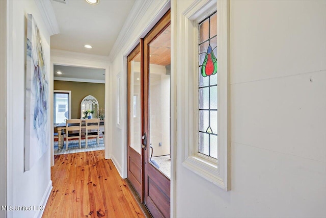 hall featuring light hardwood / wood-style floors and ornamental molding