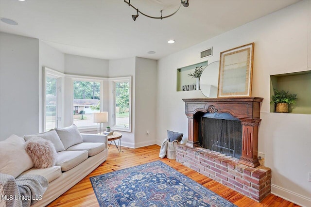 living room with hardwood / wood-style flooring and a fireplace