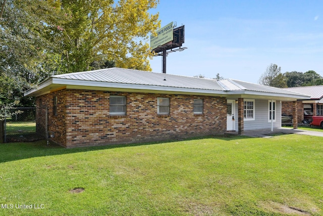 rear view of house featuring a yard