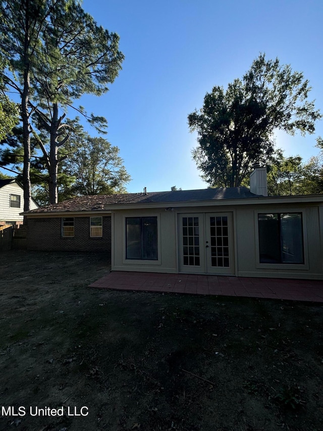 back of property featuring a yard