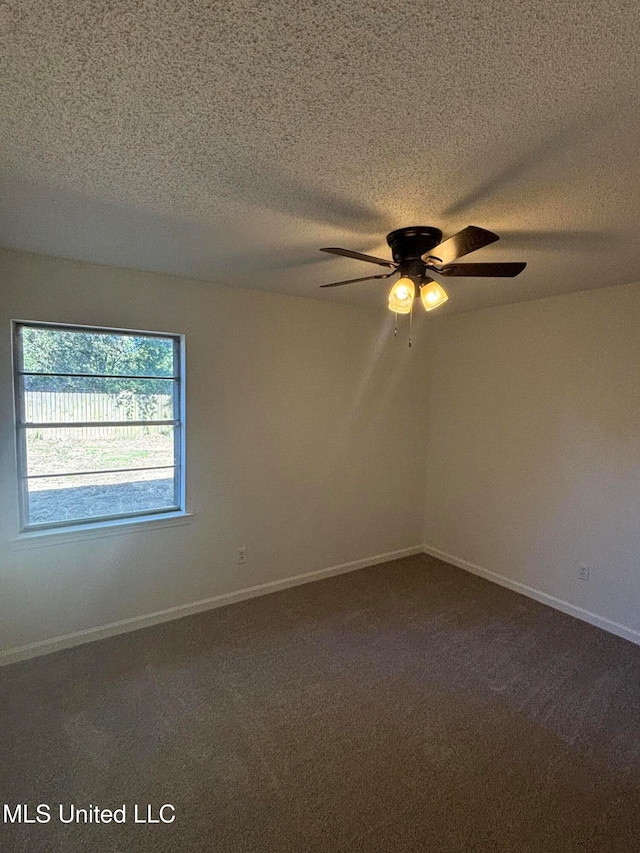 carpeted spare room with ceiling fan and a textured ceiling