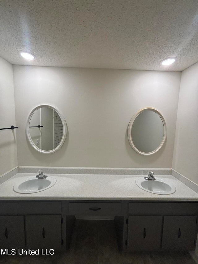 bathroom featuring vanity and a textured ceiling