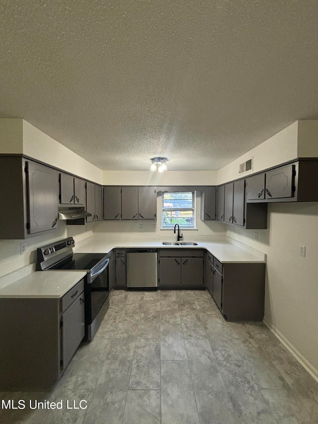 kitchen with gray cabinets, a textured ceiling, stainless steel appliances, and sink