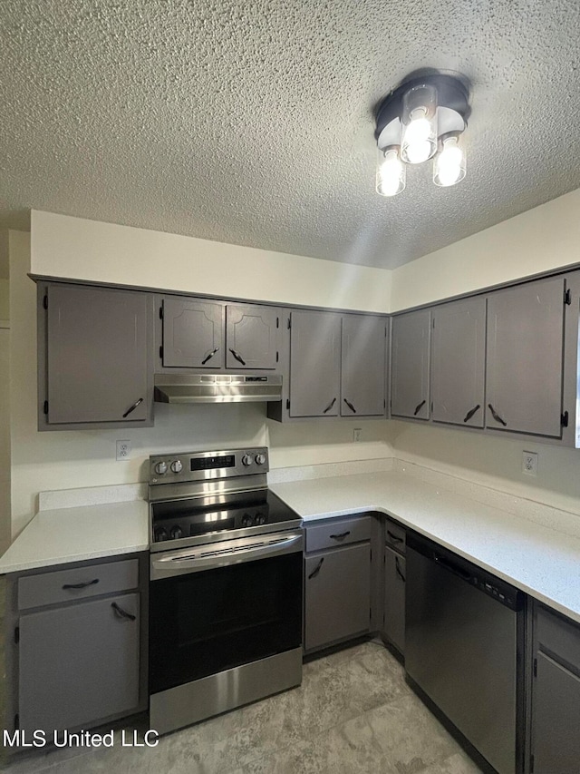 kitchen featuring stainless steel appliances, a textured ceiling, and gray cabinets