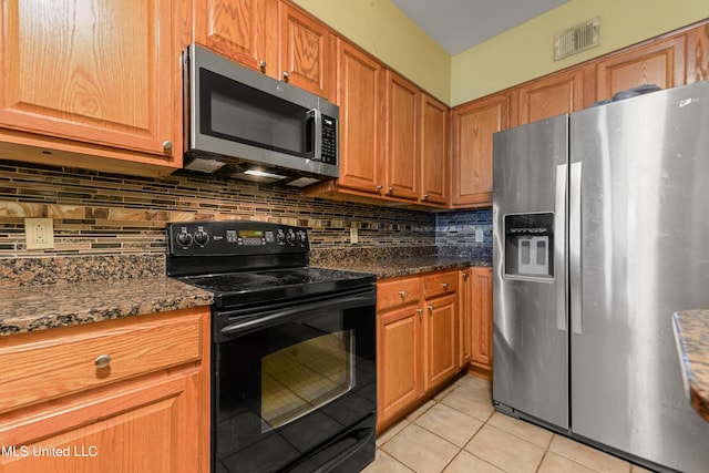 2230 Beach Dr Unit 205, Gulfport, MS 39507 - kitchen featuring stainless steel appliances, light tile patterned floors, backsplash, and brown cabinets