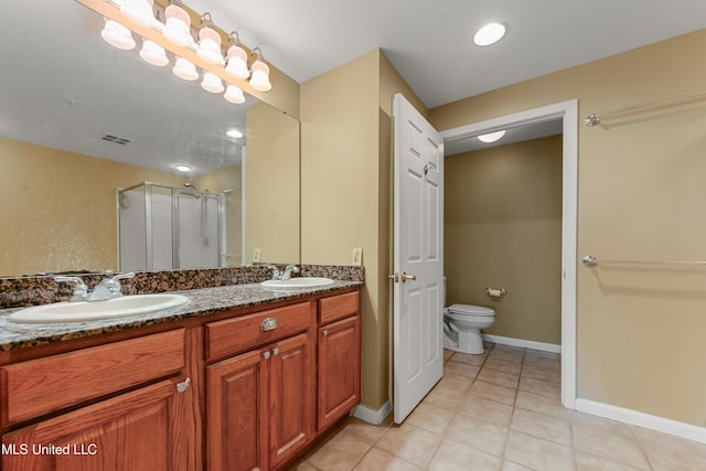 2230 Beach Dr Unit 205, Gulfport, MS 39507 - full bath featuring a shower stall, toilet, double vanity, tile patterned floors, and baseboards