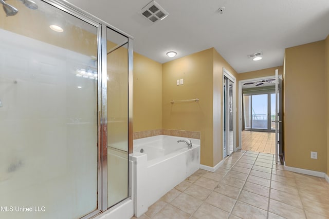 2230 Beach Dr Unit 205, Gulfport, MS 39507 - bathroom featuring tile patterned flooring, a stall shower, a bath, and baseboards