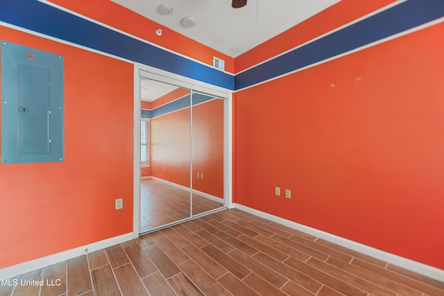 2230 Beach Dr Unit 205, Gulfport, MS 39507 - unfurnished bedroom featuring electric panel, a closet, baseboards, and wood finished floors