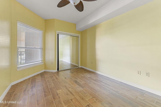 2230 Beach Dr Unit 205, Gulfport, MS 39507 - unfurnished bedroom with wood finished floors, a closet, baseboards, and a ceiling fan
