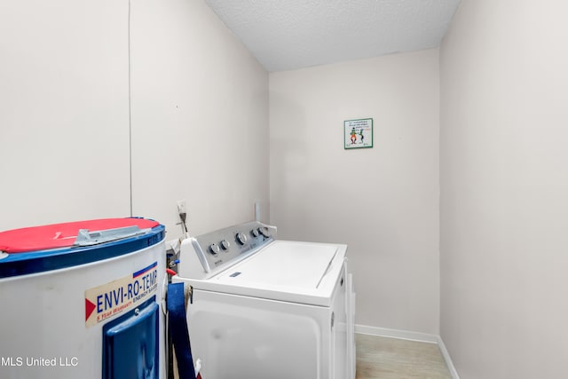 5608 Claresholm Dr, Gautier, MS 39553 - washroom with washing machine and clothes dryer, a textured ceiling, and baseboards