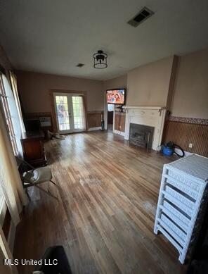 living room with french doors and wood-type flooring