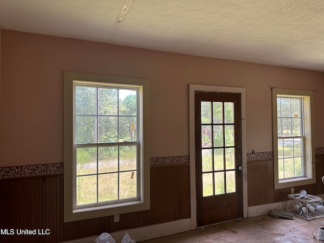 entryway with a textured ceiling and plenty of natural light