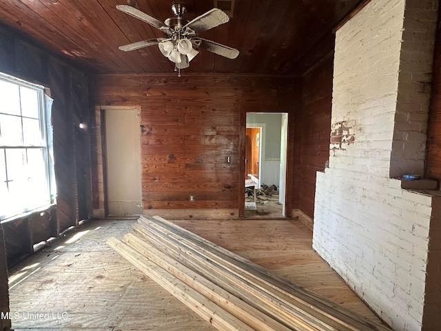 empty room with hardwood / wood-style floors, wooden ceiling, plenty of natural light, and ceiling fan