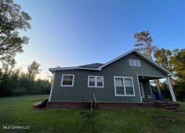 back of house with a lawn