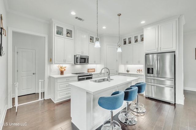 35 Enclave Cir, Ridgeland, MS 39157 - kitchen featuring stainless steel appliances, a sink, dark wood-style flooring, glass insert cabinets, and ornamental molding