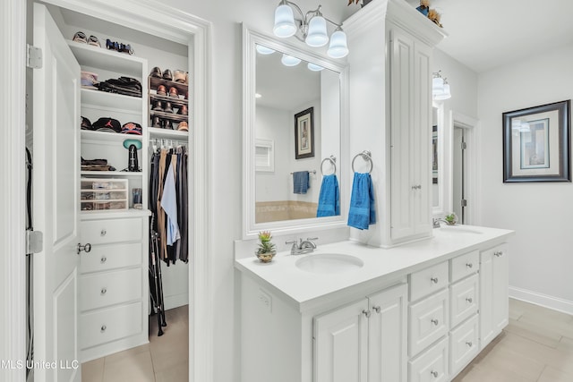 35 Enclave Cir, Ridgeland, MS 39157 - full bathroom featuring tile patterned floors, double vanity, a walk in closet, and baseboards