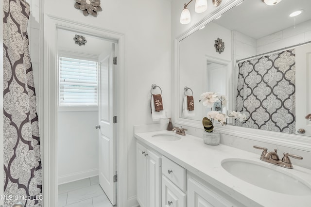 35 Enclave Cir, Ridgeland, MS 39157 - bathroom featuring marble look tile flooring, double vanity, baseboards, and curtained shower