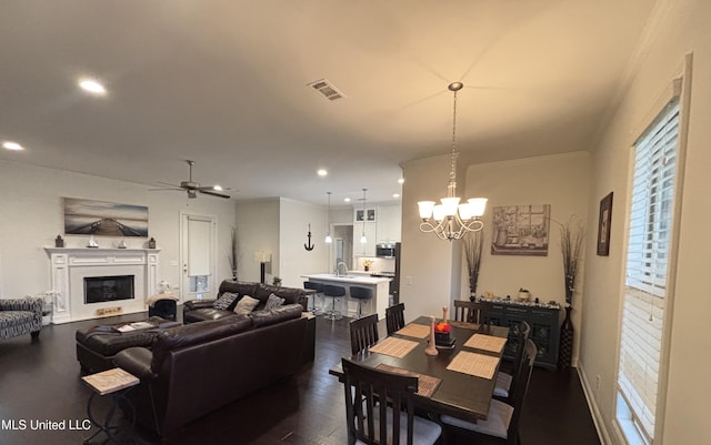 35 Enclave Cir, Ridgeland, MS 39157 - living area with a chandelier, recessed lighting, dark wood-style flooring, a glass covered fireplace, and a ceiling fan