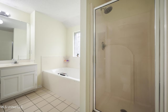 bathroom with a shower stall, a garden tub, vanity, and tile patterned flooring