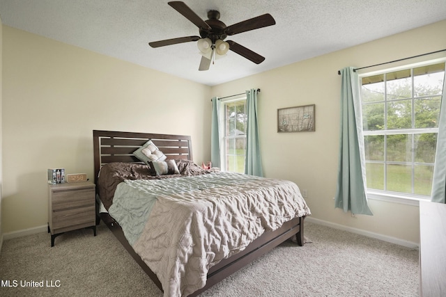 carpeted bedroom featuring baseboards and ceiling fan
