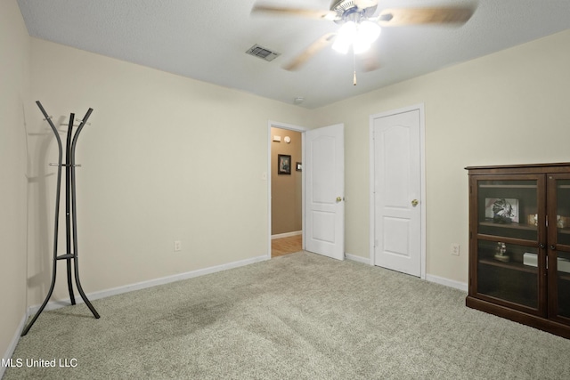 unfurnished bedroom with carpet floors, baseboards, and a ceiling fan