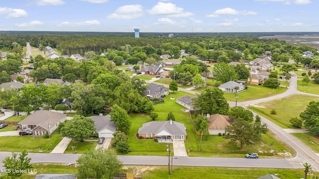 aerial view of residential area featuring a heavily wooded area