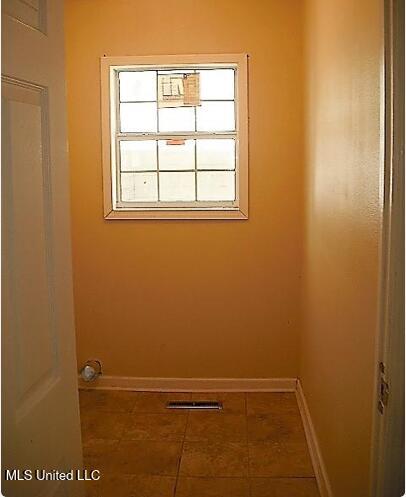 1105 Military Rd, Columbus, MS 39701 - washroom featuring baseboards and tile patterned flooring