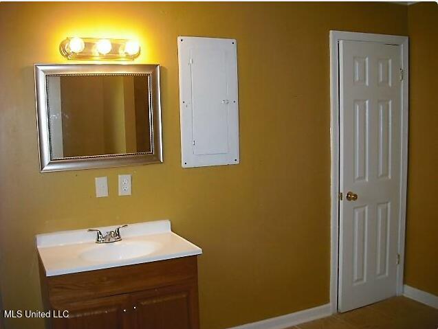 1105 Military Rd, Columbus, MS 39701 - bathroom featuring electric panel and vanity