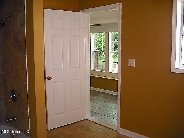 1105 Military Rd, Columbus, MS 39701 - hallway featuring baseboards and tile patterned floors