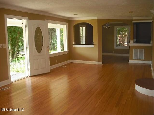 1105 Military Rd, Columbus, MS 39701 - foyer with ornamental molding, wood finished floors, and arched walkways