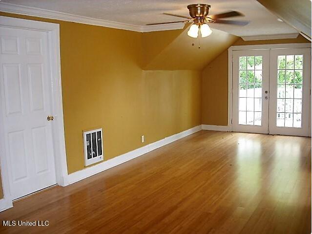 1105 Military Rd, Columbus, MS 39701 - additional living space featuring heating unit, wood finished floors, ceiling fan, and vaulted ceiling