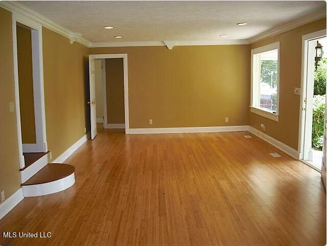 1105 Military Rd, Columbus, MS 39701 - spare room with crown molding, light wood finished floors, and recessed lighting