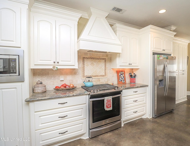 kitchen with visible vents, appliances with stainless steel finishes, light stone countertops, finished concrete floors, and custom exhaust hood