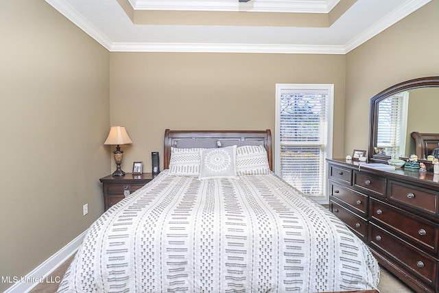 bedroom featuring carpet floors, ornamental molding, a raised ceiling, and baseboards