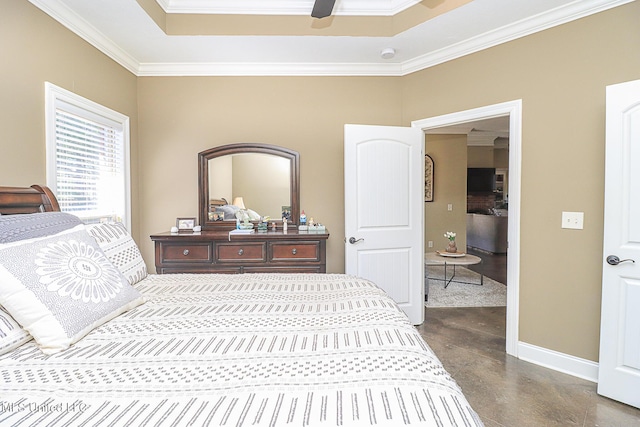 bedroom featuring ornamental molding, a tray ceiling, baseboards, and a ceiling fan