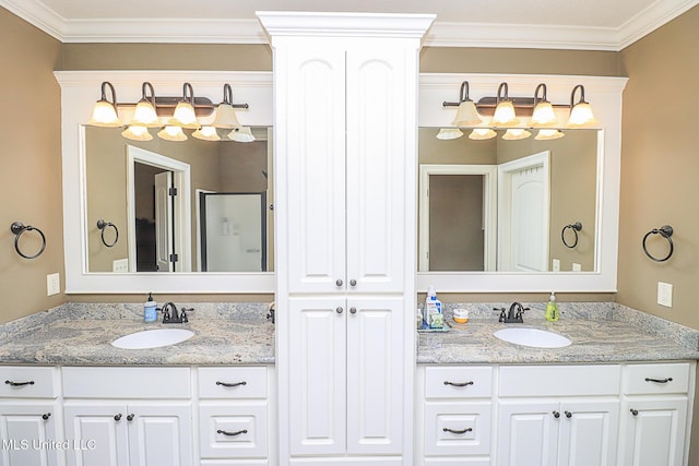 full bathroom featuring crown molding, two vanities, and a sink