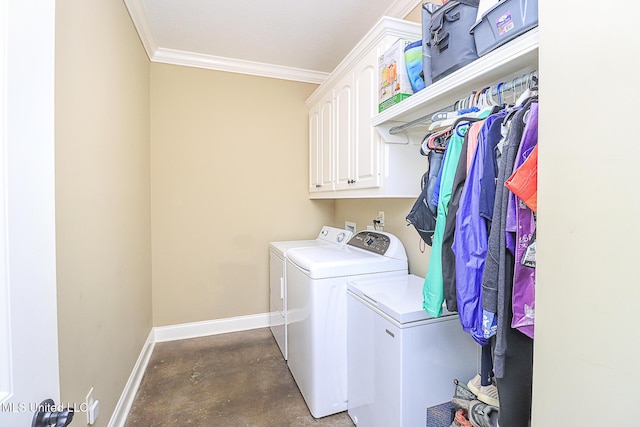 laundry area with cabinet space, baseboards, washer and clothes dryer, and crown molding