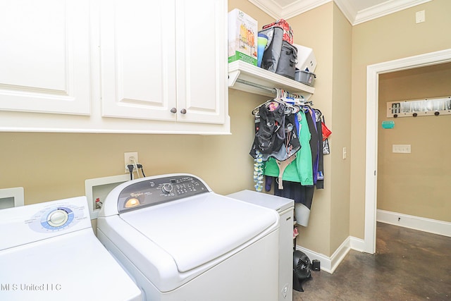 laundry area featuring washer and clothes dryer, cabinet space, and baseboards