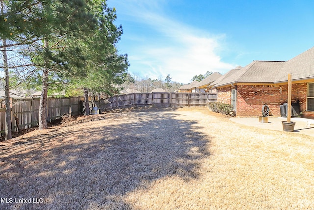 view of yard with a fenced backyard and a patio