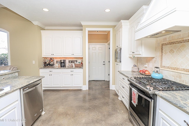 kitchen featuring white cabinetry, premium range hood, and appliances with stainless steel finishes